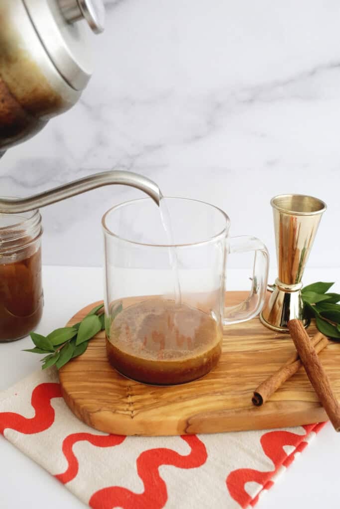 pouring hot water into hot buttered rum